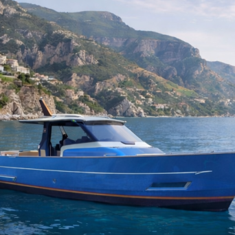 Blue boat on calm sea with scenic coastal cliffs in background.