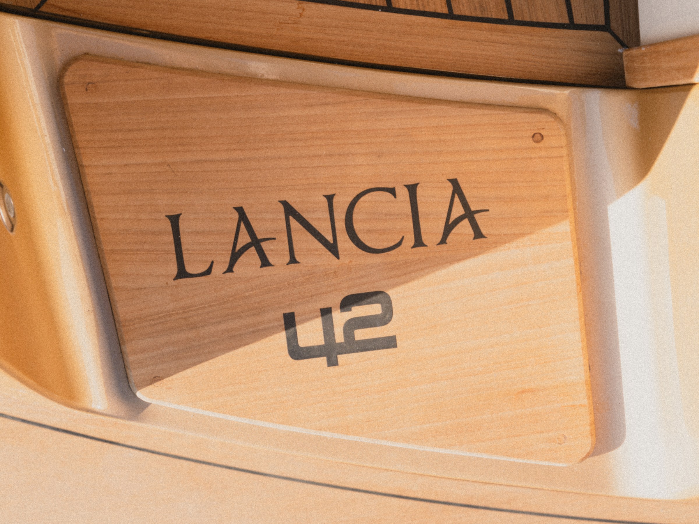 Wooden plaque with 'LANCIA 42' engraved.